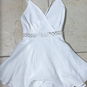 cute white romper with adjustable straps with criss cross back design size M